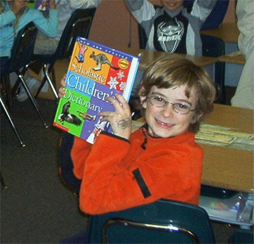 Boy holding dictionary (2003-face-with-dic